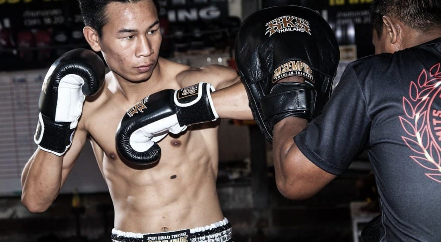 Muay Thai fighter training with boxing gloves in a Thai gym