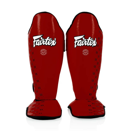 Red Fairtex shin guards on a white background